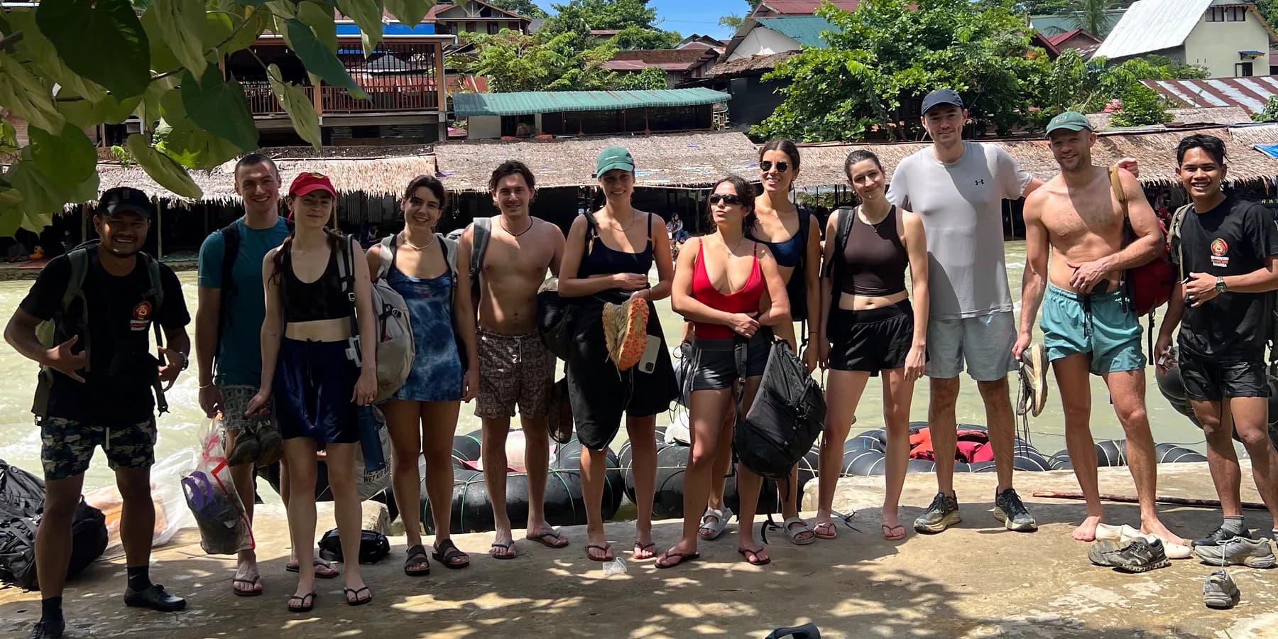 Guests and local guides beside the river in Bukit Lawang